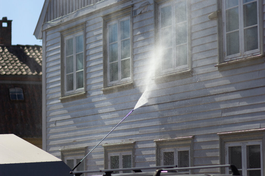 Window soft wash exterior cleaning service on a residential property